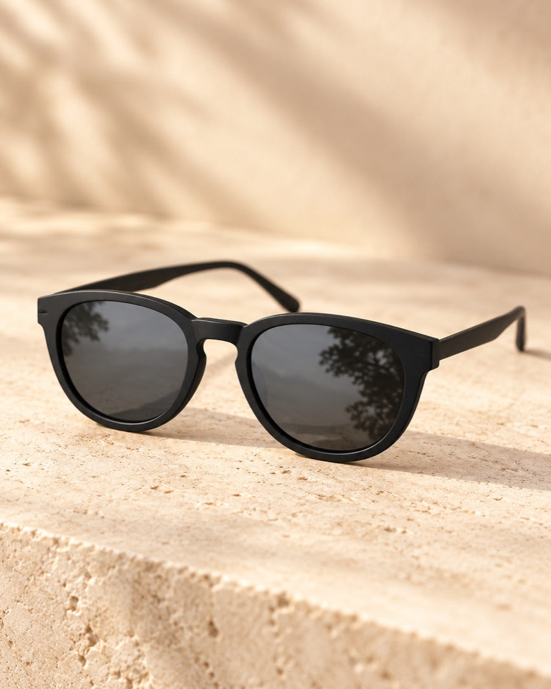 HUNA Dark Black Polarized Sun Lens mounted on matte black optical frame